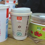 The color-coding was also utilized on the packaging and service ware — as shown above in the top symbol on the McDonald’s cups and container — to match with the proper receptacle, in this case, orange for composting.