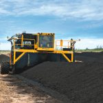 Manure is removed from the feedlot with a bucket loader and hauled to laydown yards adjacent to the individual lots. Windrows are formed approximately 14 to 16 feet wide at the base, and 5 to 6 feet tall.