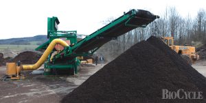 A vacuum separator positioned over the output conveyor of the trommel removes remaining contaminants from the screened compost.
