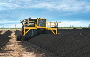 Manure is removed from the feedlot with a bucket loader and hauled to laydown yards adjacent to the individual lots. Windrows are formed approximately 14 to 16 feet wide at the base, and 5 to 6 feet tall. 