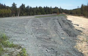 Approximately 5 acres of the gravel pit received 6 to 8 inches of compost that had been aged for several years. A bulldozer was used to spread the material.