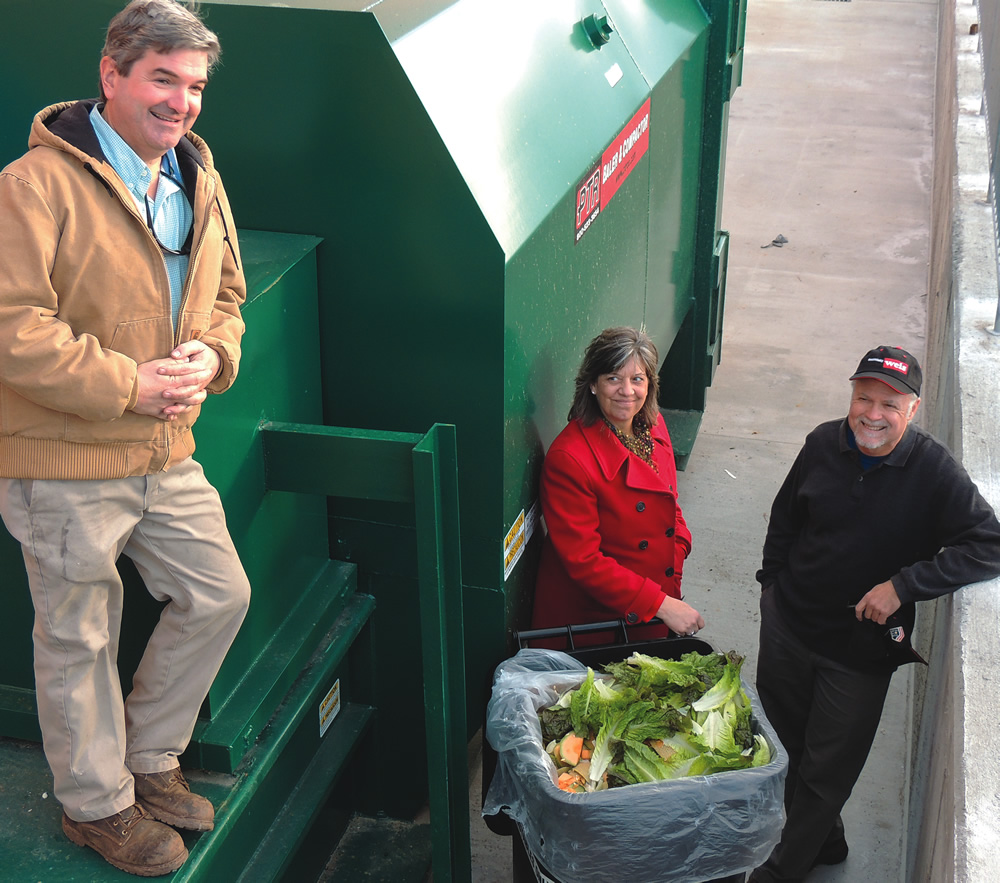 “For stores with compactors we can reduce the size from 40 cubic yards to 20 cubic yards,” says Patti Olenick (center), Sustainability Manager at Weis Markets, Inc. Also pictured are Ned Foley (left), owner of Two Particular Acres and Al Rattie (right) of the US Composting Council.