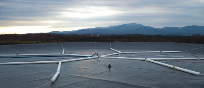 Joneslan Farm in Hyde Park milks about 200 cows. It installed a UEM digester, which has a prefabricated, insulated 240,000-gallon geomembrane tank. Weighted pipes keep biogas under the cover pressurized.