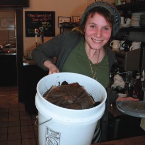 Coffee grounds from Clingman Café (shown by barista Genevieve Van Zandt) are one of the main ingredients used by Asheville Fungi in its mushroom-growing substrate.