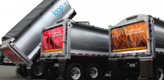 King County biosolids transport trucks promote Loop, featuring scenes of flowers in bloom, Washington forests or wheat fields.