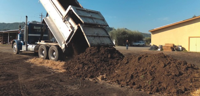 Composting at Preston Vineyards takes place in a roughly 60-by-200 foot area behind some farm buildings. Feedstocks include wood chips, mown grass, grape and olive pomace and organic dairy manure.