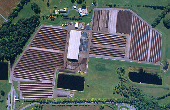 The Montgomery County yard trimmings composting facility sits on a 48-acre asphalt pad. After curing, compost is moved under an 80,000 square foot pavilion (center), where it is allowed to fully mature.