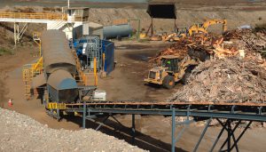 A portion of electricity generated by the CHP units is wheeled to the Zanker Road Resource Recovery Operations and Landfill — which processes segregated materials such as wood waste and asphalt shingles — to power stationary equipment such as the Peterson horizontal grinder on left of photo. 