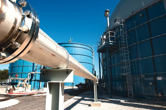 The codigestion facility includes a mixing tank, two complete mix anaerobic digesters operated in parallel, and a post digestion tank with a biogas holder mounted to the top (seen at right).