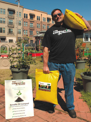 An employee at The Composting Network, LLC holds bags of finished compost made with food scraps the company collects from businesses and institutions in New Orleans.