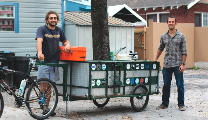 Steven Kanner, Chief Systems Engineer (left), and Chris Cano, Compost Experience Officer (right), owners of Gainesville Compost, pictured with the 500-lbs capacity bike trailer that Kanner created for bike-powered food scraps hauling in Gainesville.