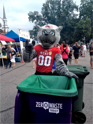 Mr. Wuf, mascot for North Carolina State University, stands next to a Zero Waste Today collection tote at the Town of Cary’s 2012 Lazy Daze Festival. 