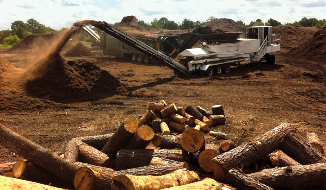 A Diamond Z tub grinder processes material after composting and before curing.