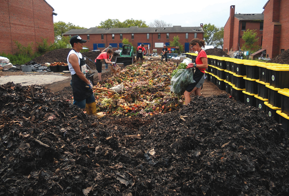 Volunteers assist with mixing foods scraps from New York City’s Greenmarkets with an equal amount of preblended carbon amendment to create an aerated static pile. Earth Matter NY cofounder Marisa DeDominicis in on right.
