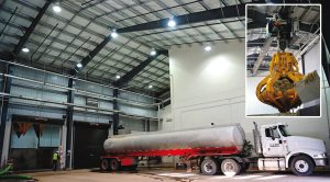 Delivery trucks unload feedstocks, sourced from a 60-mile radius of the plant, inside the receiving and preprocessing building. Solids are moved via an automatic crane (inset).