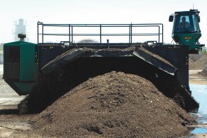 Chamness processes about 70,000 tons/year of organics, including pre and postconsumer food waste and yard trimmings, at its composting site in Eddyville. Windrows are turned with an ALLU unit.