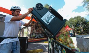 Gainesville Compost’s custom-built scrap hauling trailer includes a dumping mechanism to assist staff with lifting full totes that can weigh upwards of 200 lbs.