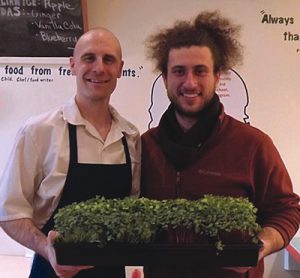 Justin Vrany (left), owner of Sandwich Me In, and Alex Poltorak hold the red rose radishes and daikon radishes from Urban Canopy’s RSA (Restaurant Supported Agriculture) program.