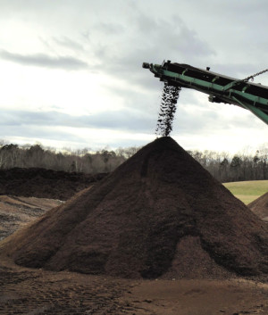 Earth Farms’ compost (being screened above) is certified by the USCC’s Seal of Testing Assurance.