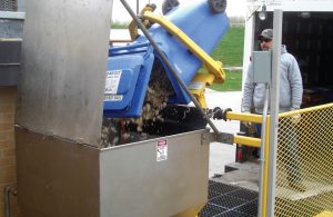 The West Lafayette (Indiana) Wastewater Treatment Utility installed a receiving station with a platform, integrated cart tipper (left) and a JWC Environmental Macho Monster grinder to handle preconsumer food scraps such as melon rinds and banana peels.