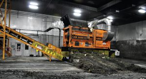 Digestate is mixed with carbon sources using an Ecoverse DW 3080 stationary shredder/blender in the enclosed receiving hall at the composting facility.