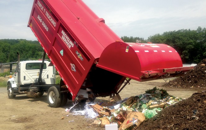 A truck with three separate compartments is used to cocollect organics, paper/ cardboard and bottles/ cans from Brattleboro residents. The compartment containing curbside organics is shown unloading (above) at the WSWMD composting facility.