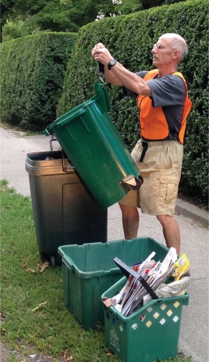 Brattleboro Recycling Coordinator Moss Kahler weighs a curbside food scraps setout.