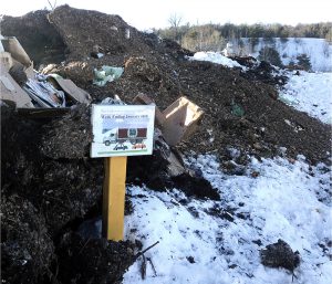 The WSWMD windrow composting facility composts a mix of food scraps and yard trimmings. Signs indicate the temperature, number of turns of the windrow and date windrow was built.
