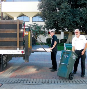 A lift-gate truck transports filled carts to a central 30 cubic yard food waste compactor.