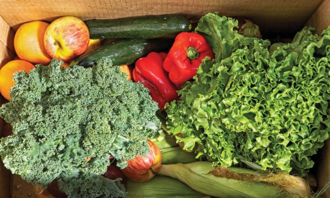 A box of produce packed for delivery.