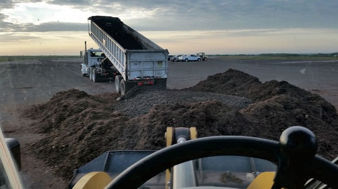 Yard trimmings ground to 6-inch minus are mixed with dewatered biosolids (15-16% solids) in a 3:1 ratio.