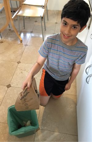 Oceanview Elementary in Albany (CA) participated in StopWaste’s 4Rs Student Action Project on wasted food prevention. Sajaad Soufiani, a 5th grader in Judith Sinclair’s class at Oceanview, places a compostable bag filled with wasted food into a compost pail at home.