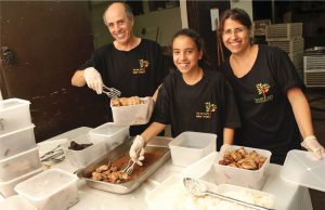 Leket Israel volunteers package prepared foods donated by banquet halls, restaurants, large caterers and other generators for distribution. 