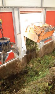 Collection vehicle tips food waste and garden trimmings into receiving pit at the Winterthur anaerobic digestion and composting facility.