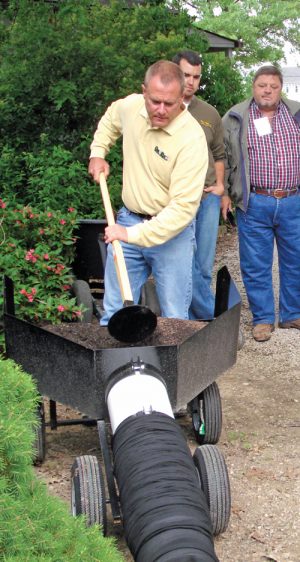 Rod Tyler demonstrates a device to fill a GardenSoxx® by hand.