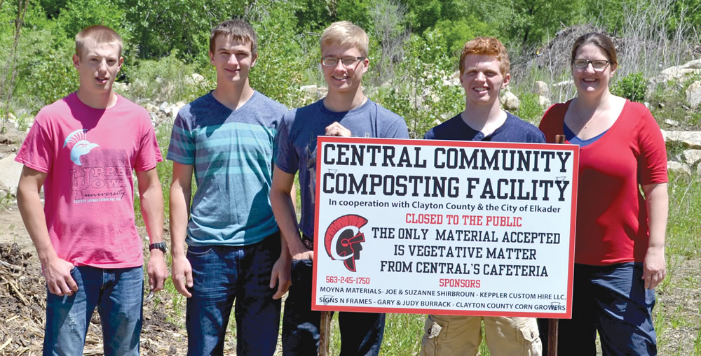 Central Community School District students with teacher, Ann Gritzner (right), showcase the new sign for their composting site.