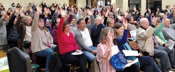 Residents at a Minneapolis open house raise their hands if they signed up for the city’s residential curbside organics collection service. Households receive a 32-gallon organics cart.