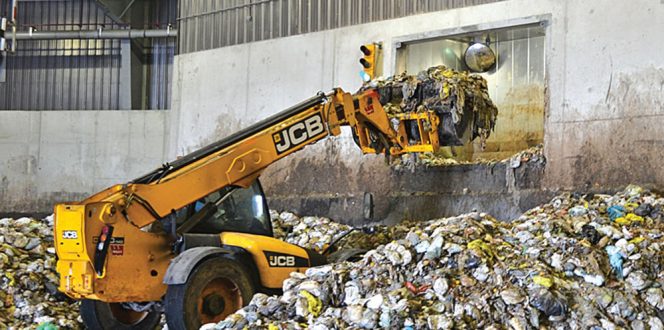 Residents are allowed to package their organics in conventional plastic bags, which are removed when the feedstock is processed prior to anaerobic digestion (above, on tip floor at Disco facility).