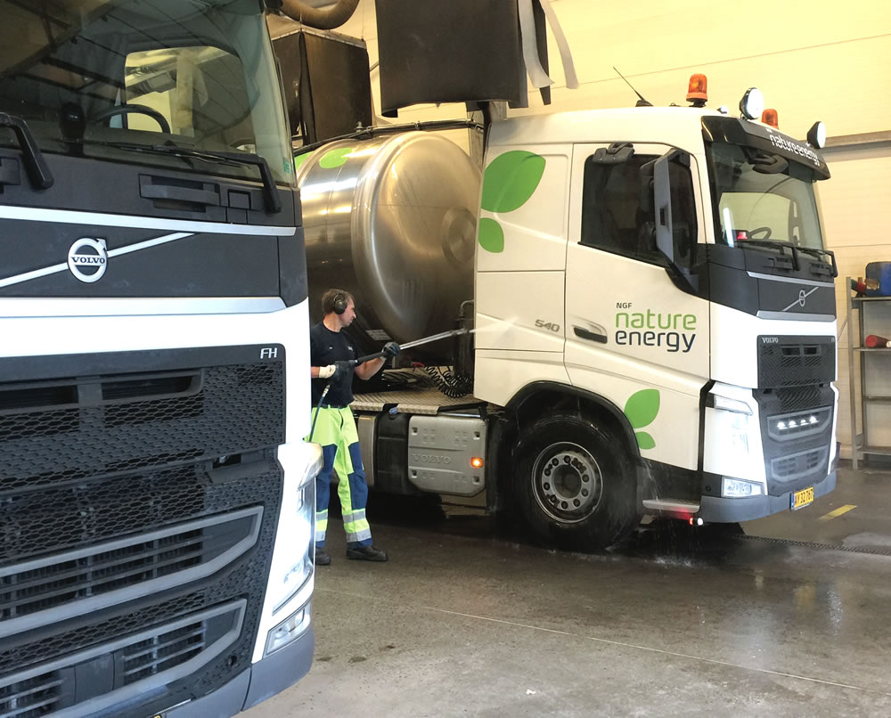 Trucks, each carrying 9,000 gallons of manure, connect to massive pumps and point source odor control equipment to offload into holding tanks. The trucks are cleaned and washed, then reloaded with liquid digestate.