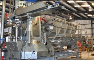 DODA Bioseparator has serrated edge counter-rotating screw augers in hopper and vertically configured hammermill and punch-plate screen.