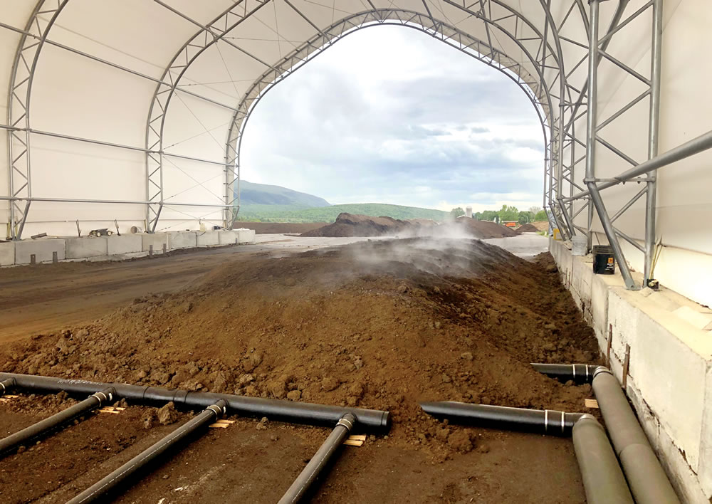 After 15 days of composting under negative aeration, separated dairy manure solids were put in a drying zone (to release steam and drive off moisture) under positive aeration with heated air.