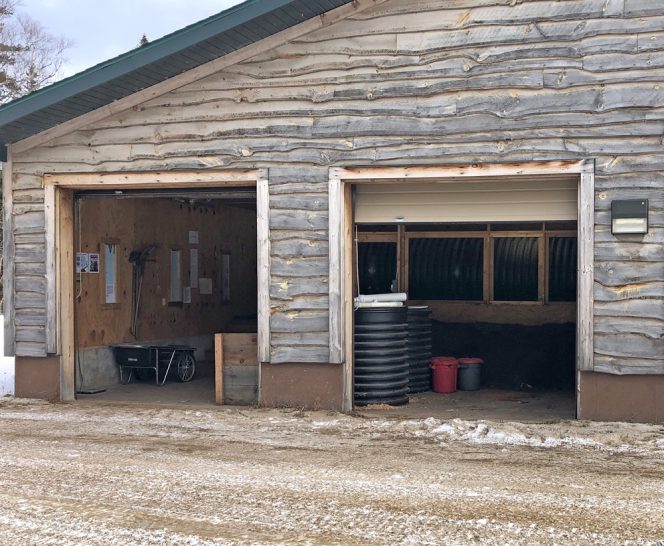 Exterior of garage at North Country Schools that has been retrofitted for drum installation (visible inside right-hand door).