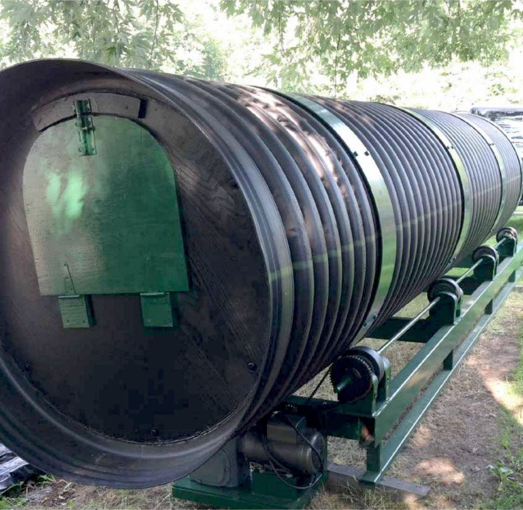 Image of Person turning drum of rotary composter